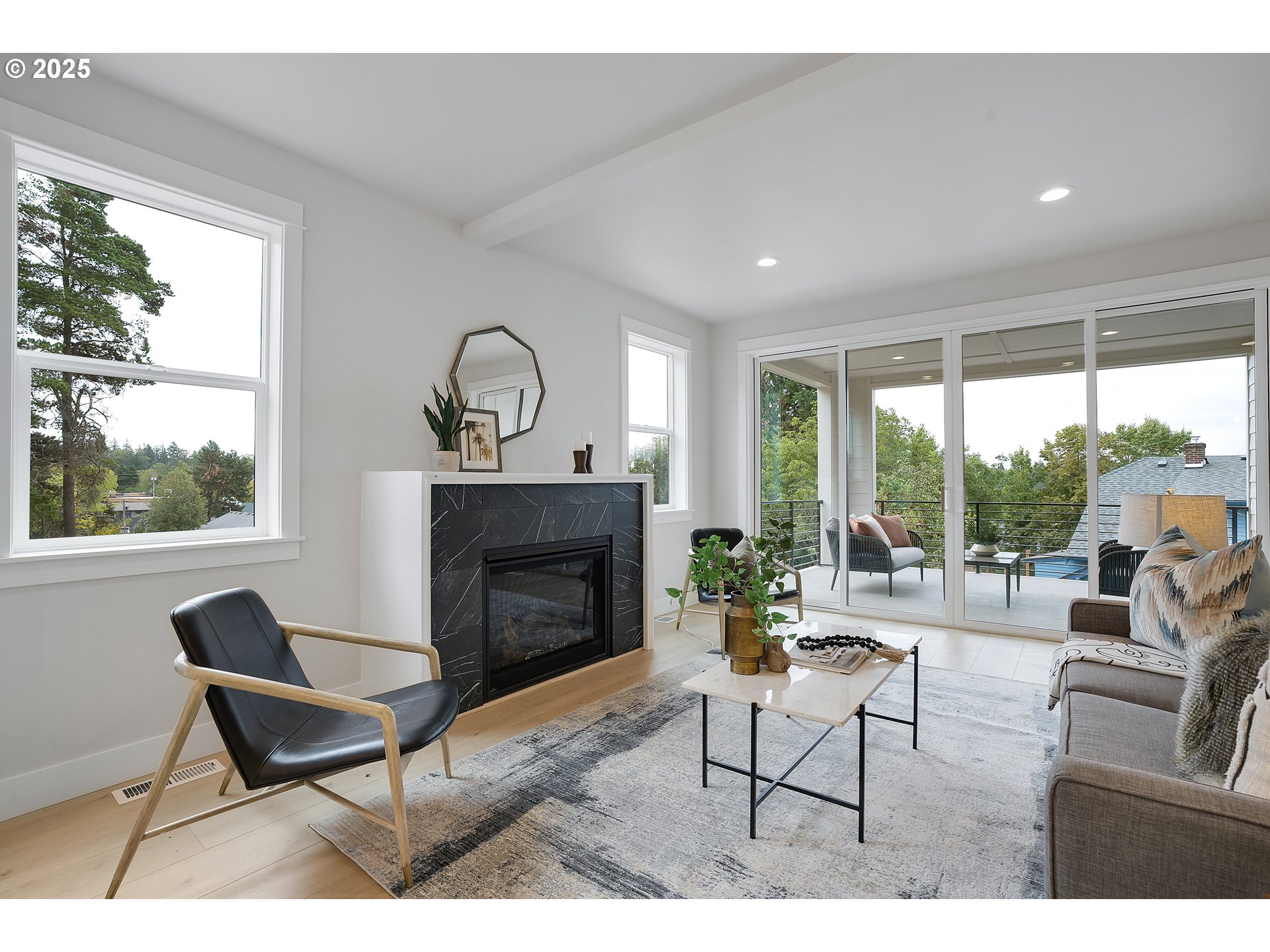 6024 Southwest 18th Drive Portland, OR 97239 - Photo 9 of 46 a living room with furniture a fireplace and a floor to ceiling window
