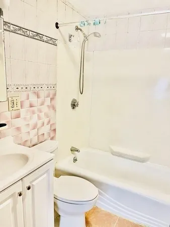 a bathroom with a shower a toilet and a sink