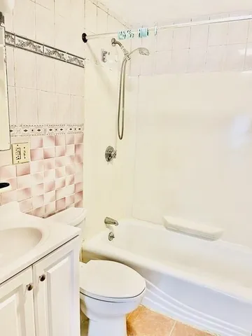 a bathroom with a shower a toilet and a sink
