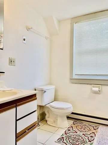 a bathroom with a toilet and a mirror