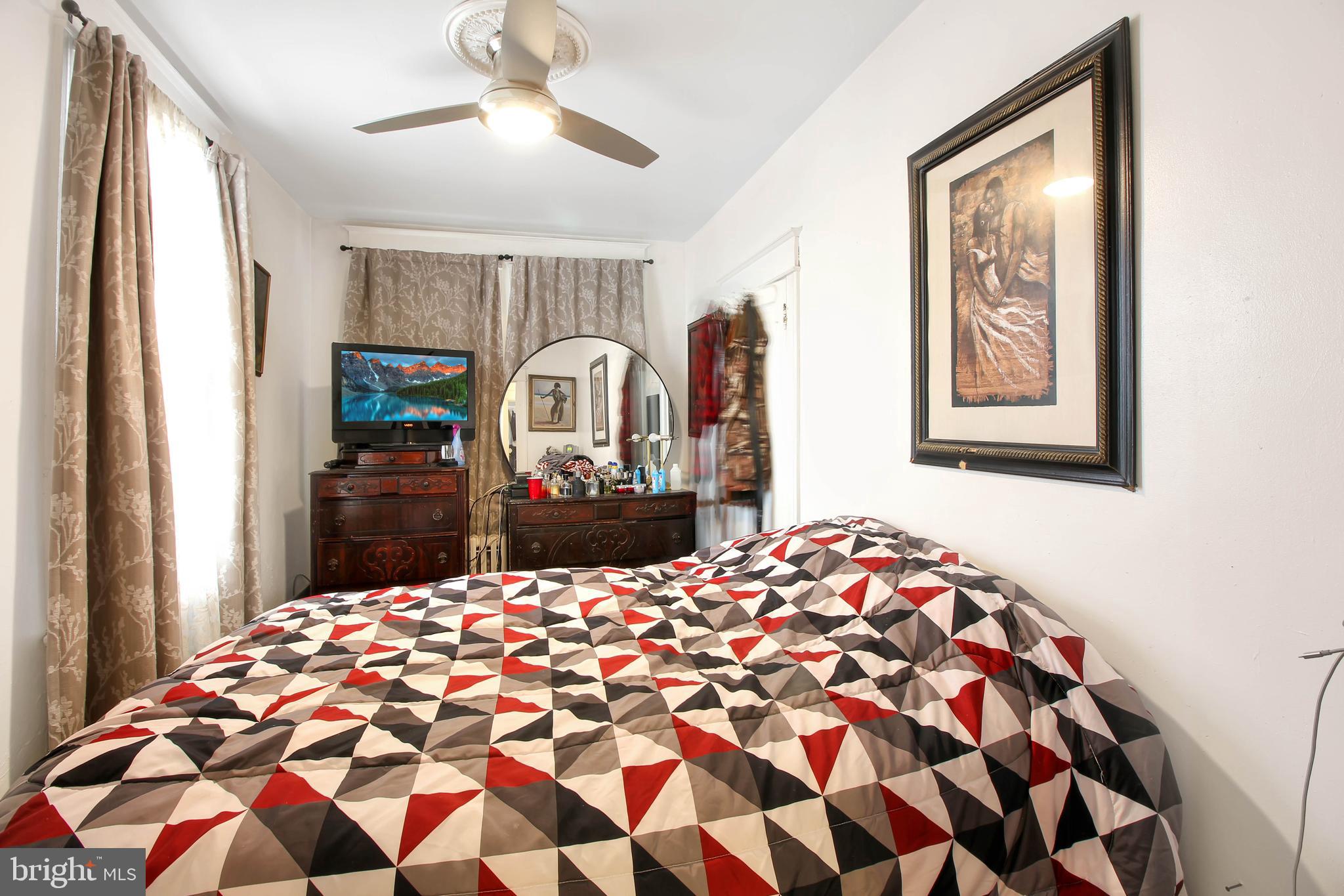 4380 Benning Road Northeast Washington, DC 20019 - Photo 9 of 14 a bedroom with a bed and a chandelier