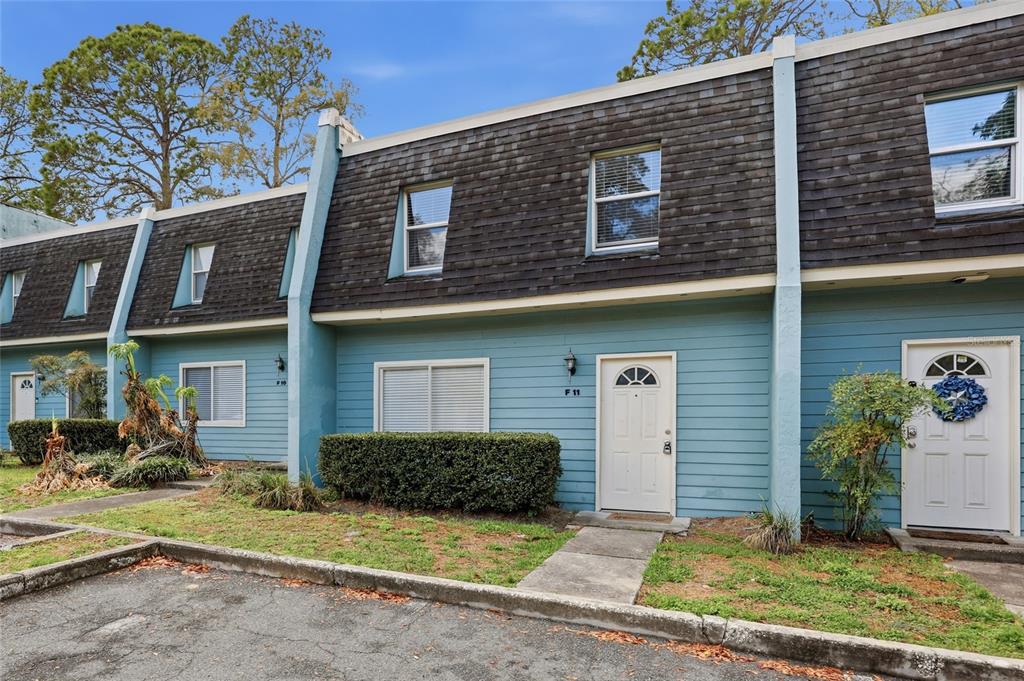 501 Southwest 75th Street, Unit F11 Gainesville, FL 32607 - Photo 1 of 1 a view of a house with large windows and a yard
