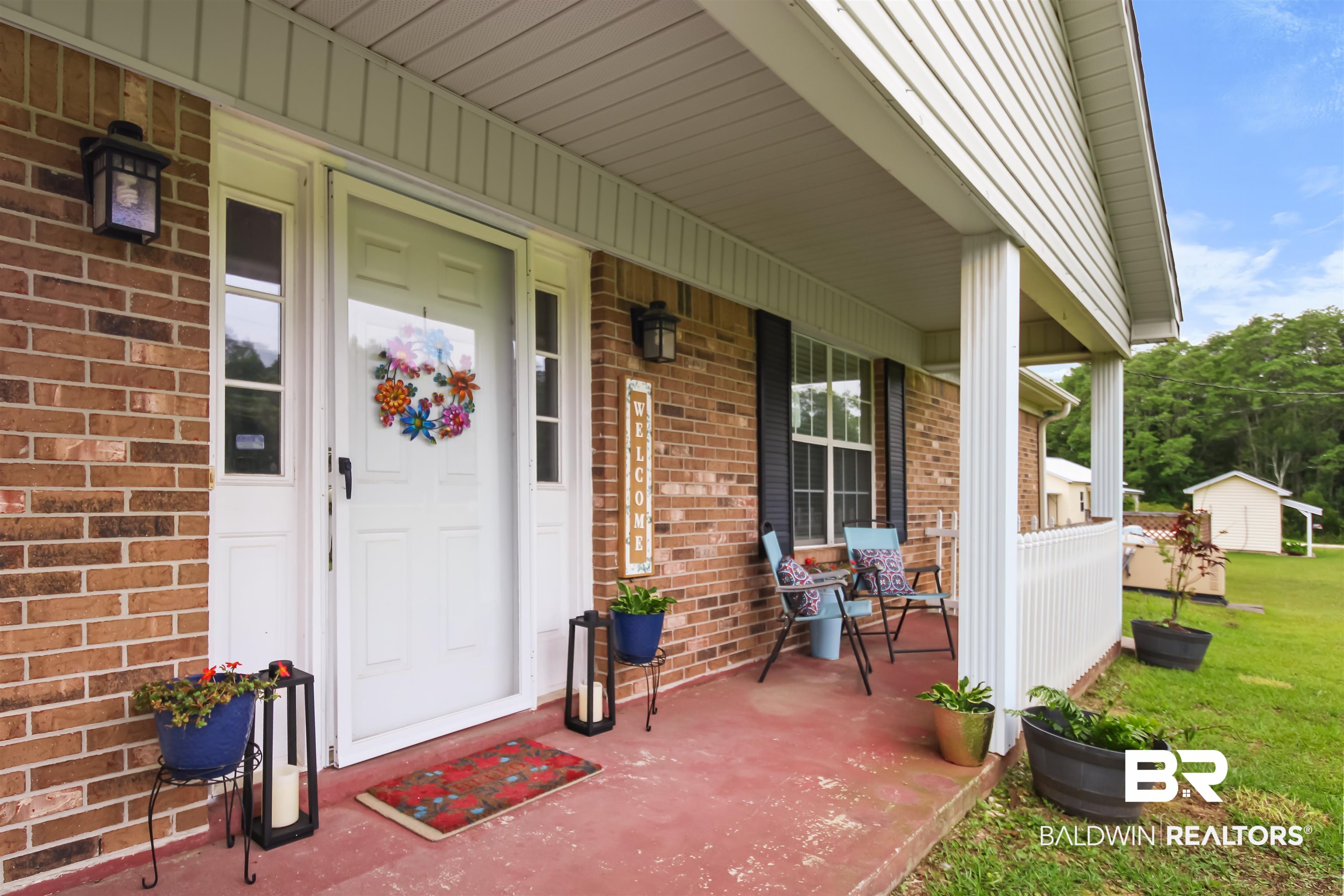 26850 Timber Lane Elberta, AL 36530 - Photo 2 of 33 View of exterior entry with a porch and brick siding