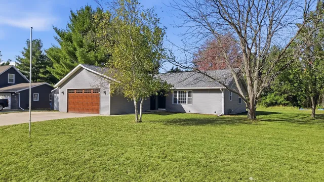 a house view with a garden and trees