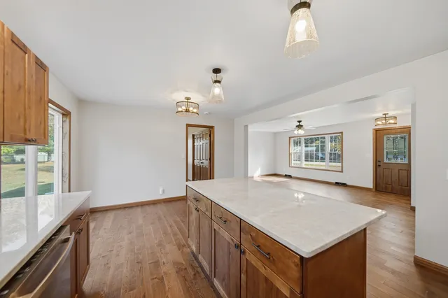 a large spacious bathroom with a granite countertop double vanity sink a mirror and a bathtub