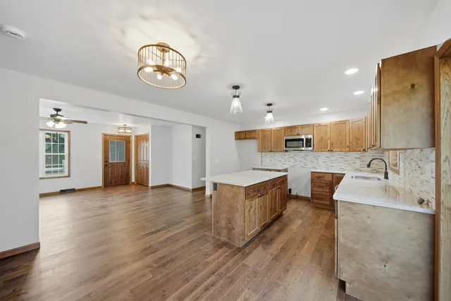 an empty room with a ceiling fan and a window
