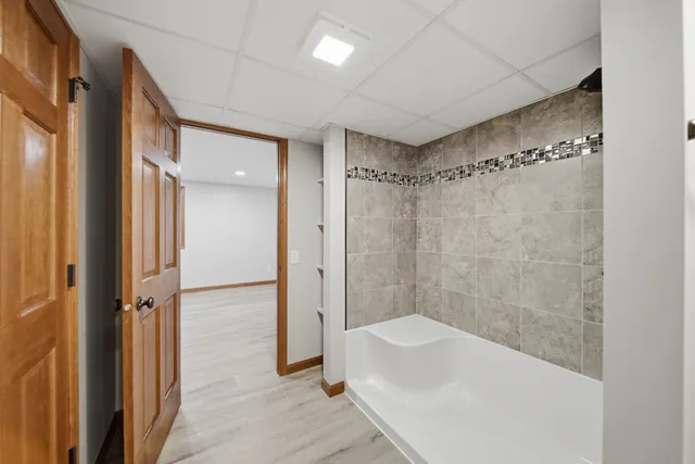 a bathroom with a bathtub shower sink vanity and toilet