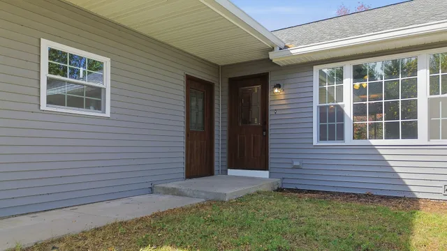 a view of a brick house with a yard