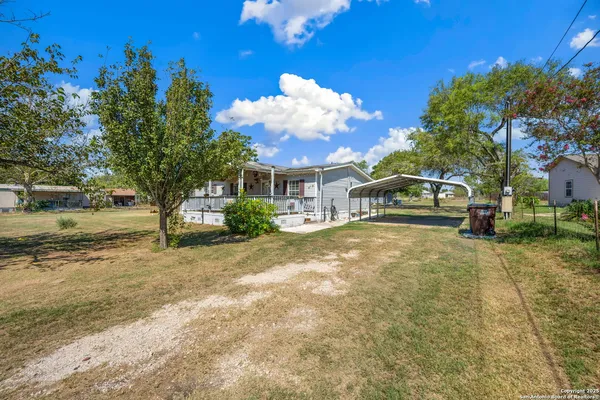 a yellow house with trees in front of it