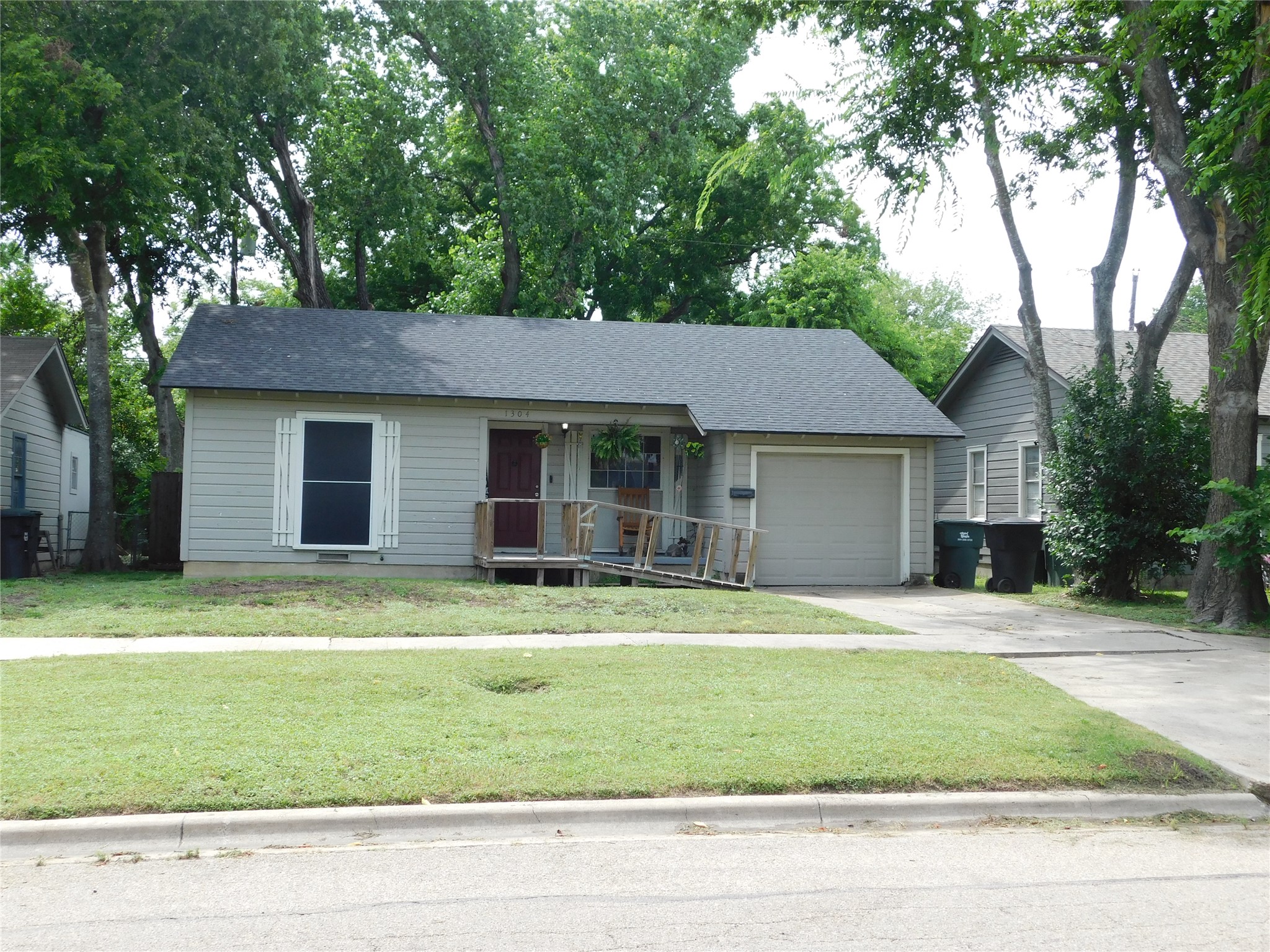 1304 South 19th Street Temple, TX 76504 - Photo 1 of 6 a house that has a big yard with large trees