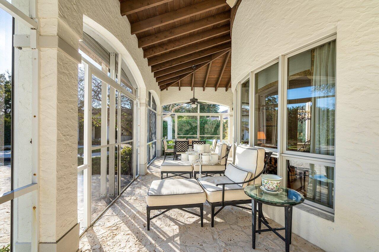 6024 Le Lac Road Boca Raton, FL 33496 - Photo 24 of 37 a patio with glass windows and furniture