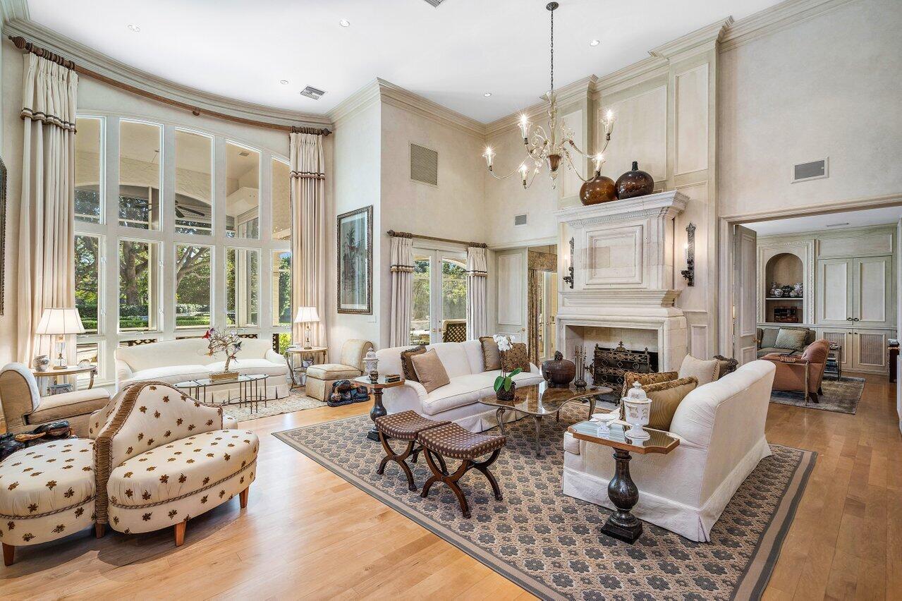 6024 Le Lac Road Boca Raton, FL 33496 - Photo 6 of 37 a living room with furniture fireplace and a large window