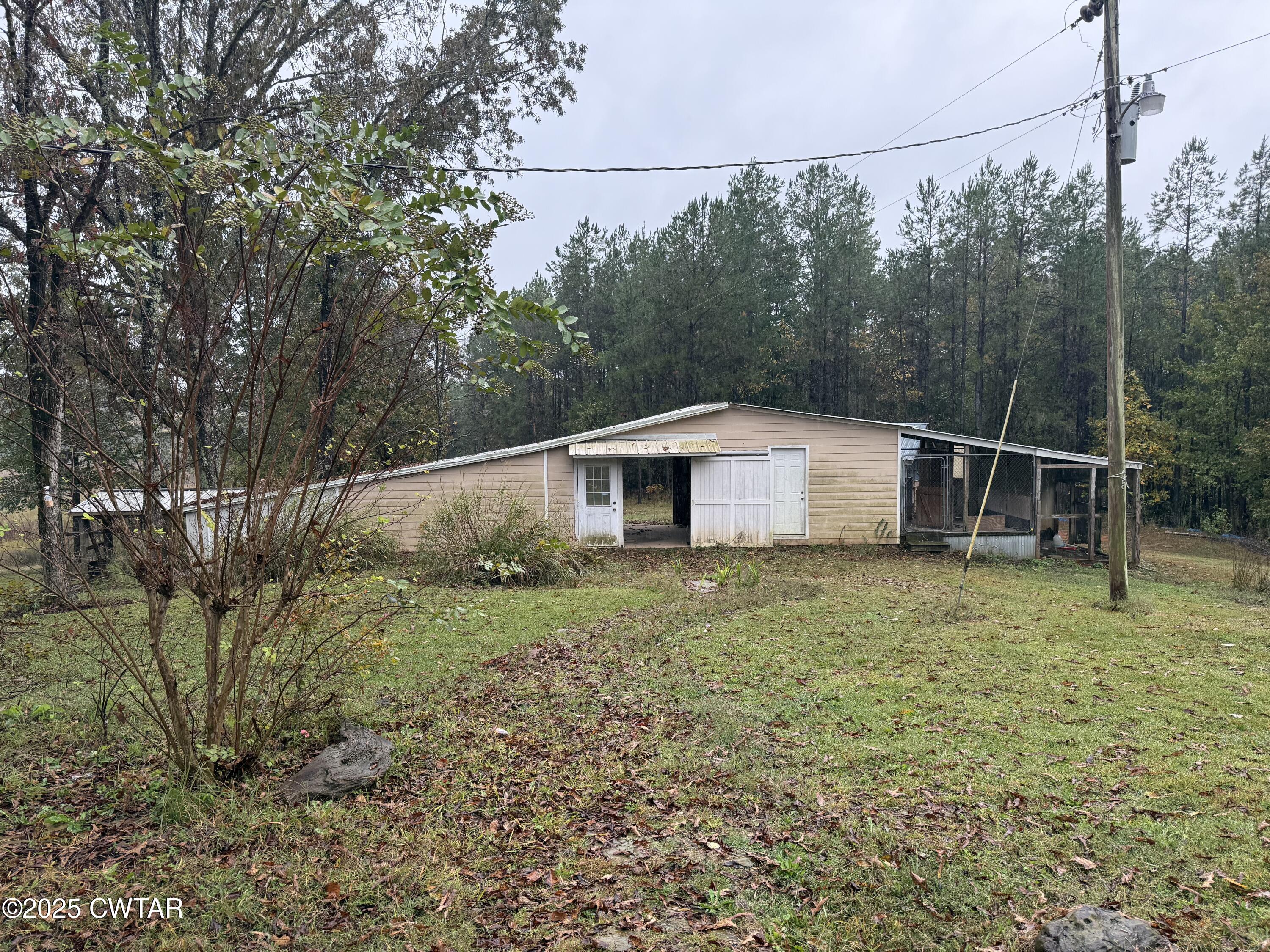 5264 Hines Gin Road Selmer, TN 38375 - Photo 13 of 19 a backyard of a house with lots of green space