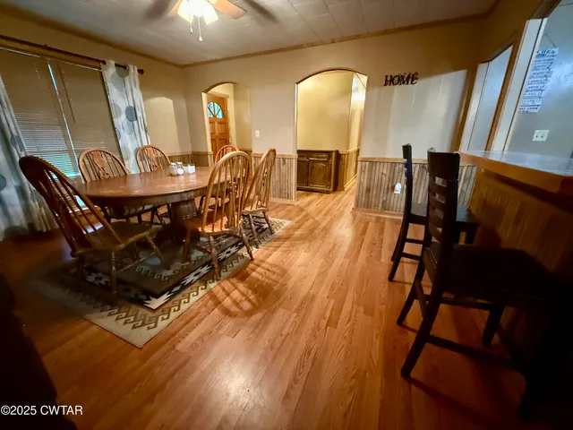 a view of a dining room with furniture and wooden floor