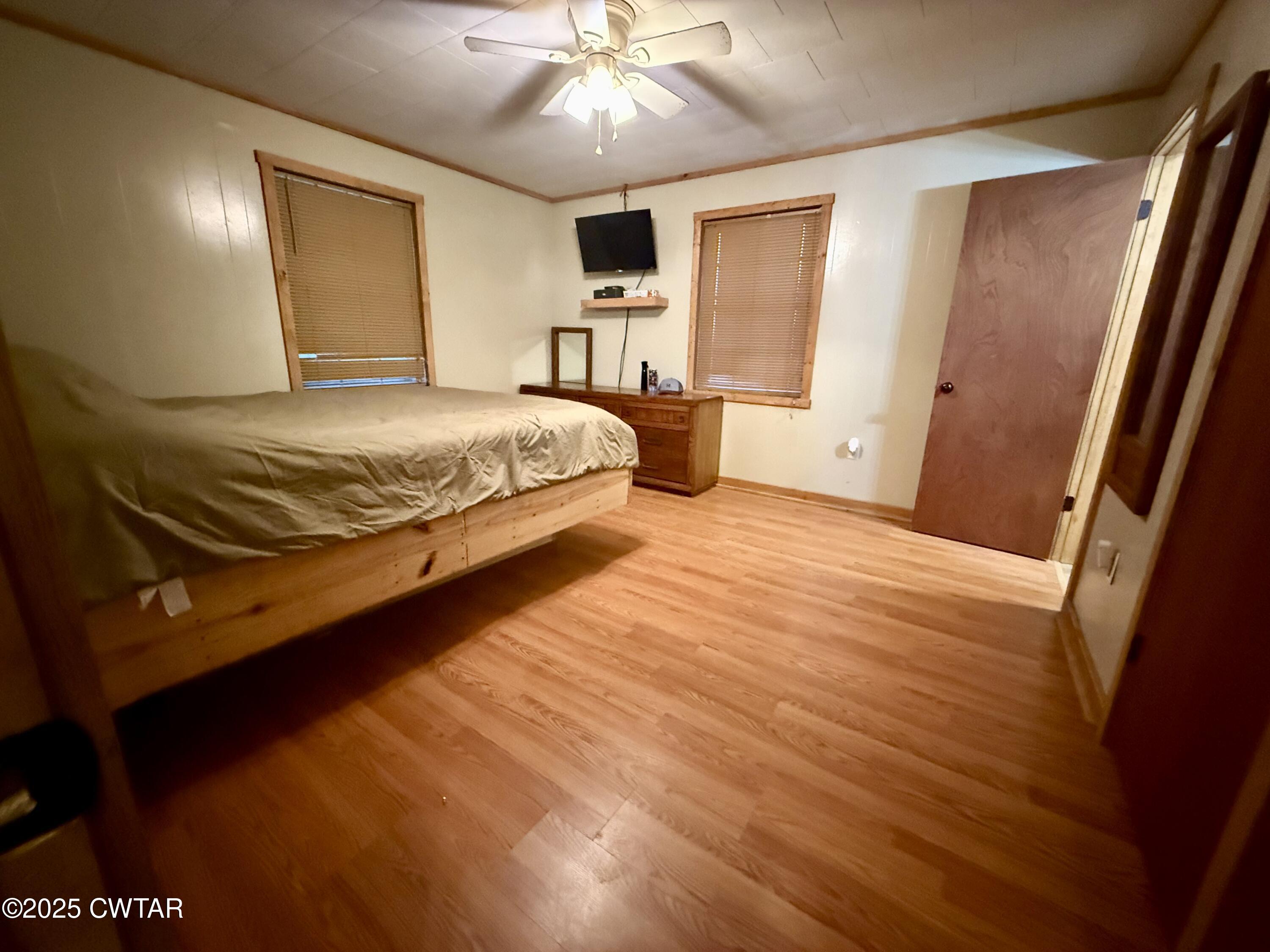 5264 Hines Gin Road Selmer, TN 38375 - Photo 6 of 19 a bedroom with a bed and a chandelier