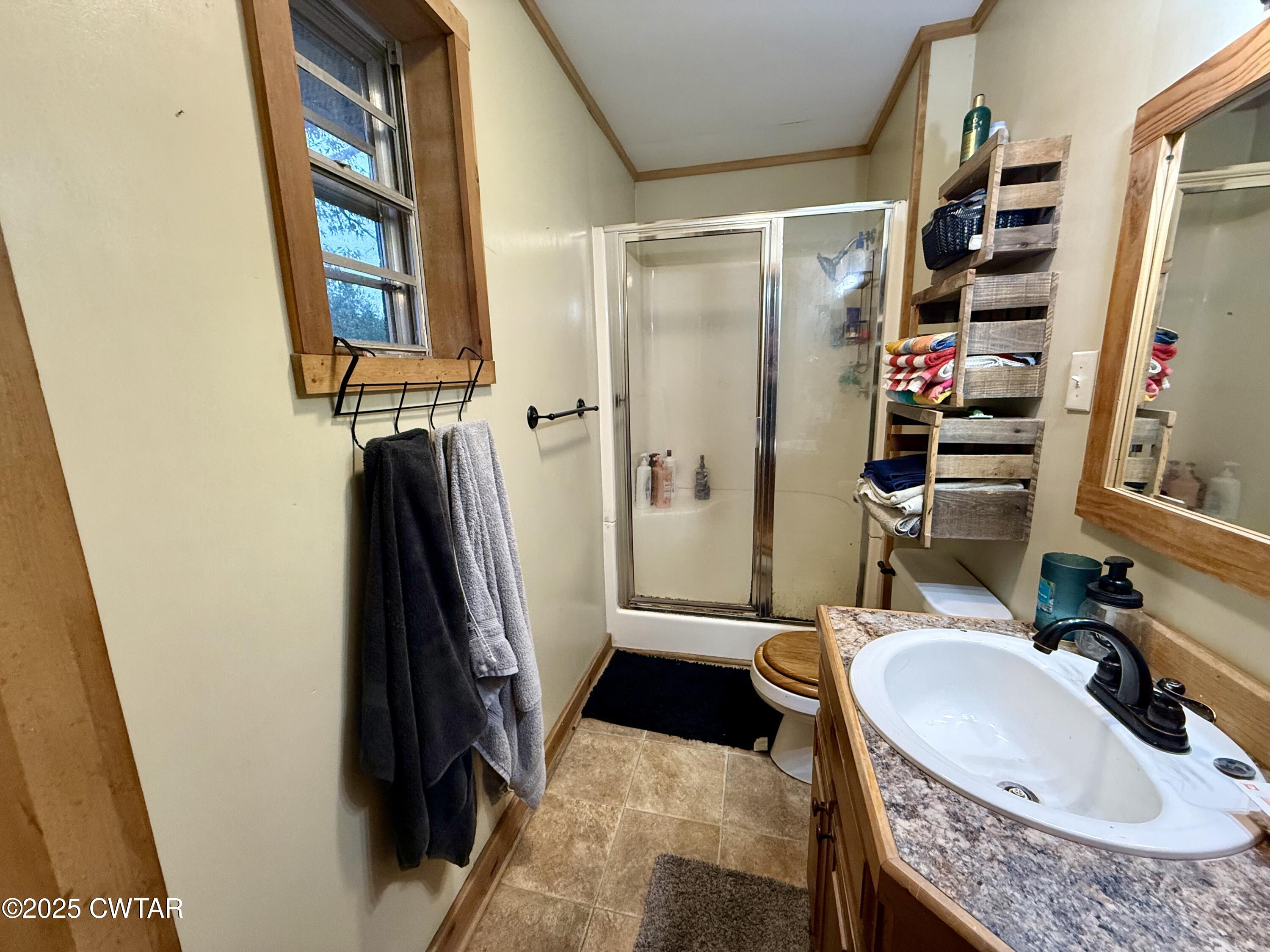 5264 Hines Gin Road Selmer, TN 38375 - Photo 7 of 19 a bathroom with a tub sink and a mirror