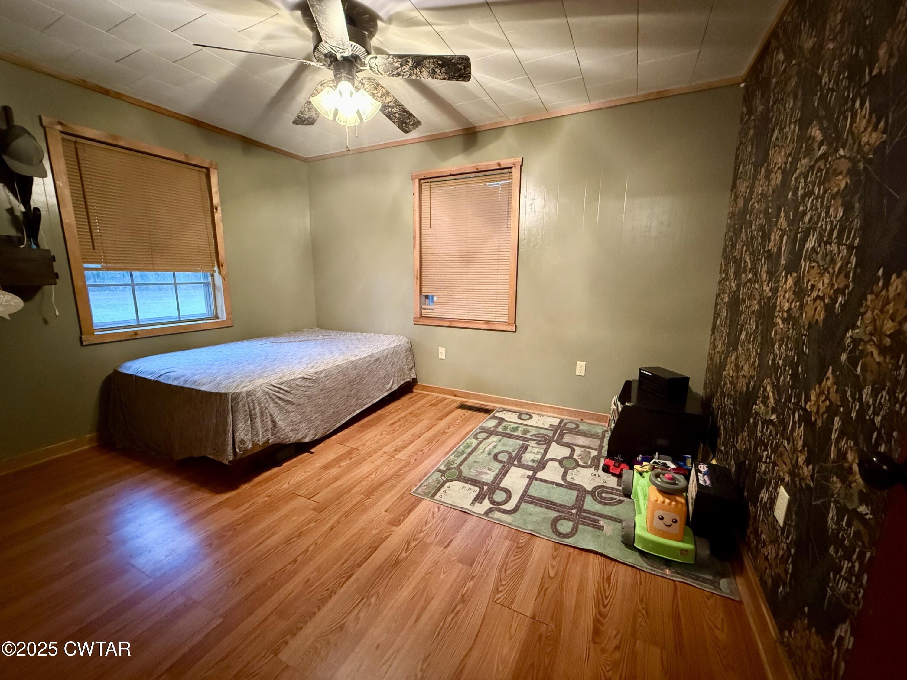 5264 Hines Gin Road Selmer, TN 38375 - Photo 8 of 19 a bedroom with a bed and a chandelier