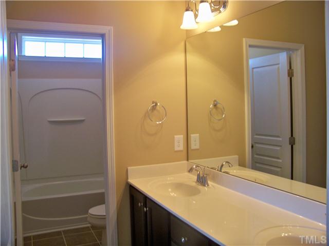 9132 Wooden Road, Unit 261 Raleigh, NC 27617 - Photo 16 of 23 A full bath is on every level of this home, plus a powder room on the main level for guests. This bathroom is located on the third-floor with direct access to one of the bedrooms. The door allows someone to shower while another is brushing teeth.