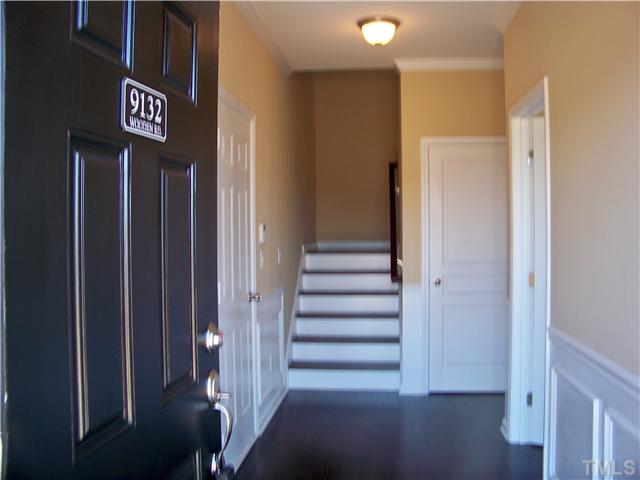 9132 Wooden Road, Unit 261 Raleigh, NC 27617 - Photo 2 of 23 The main entrance of this home is accessed from the side covered porch encased by a brick archway. The foyer is covered with crown molding, chair rail, wainscotting & hardwood floors.