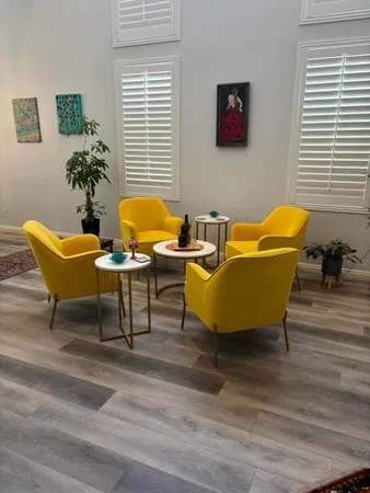 a living room with furniture ceiling fan and a rug