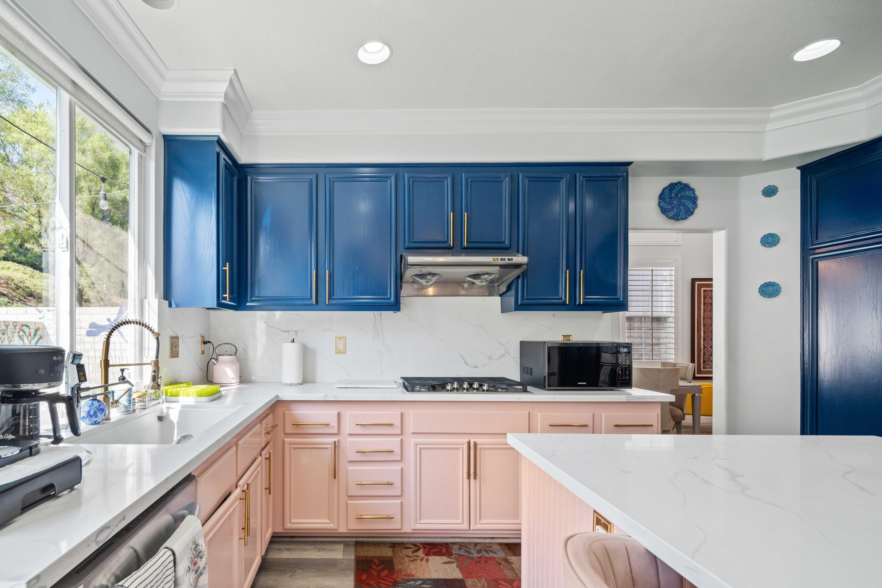 26089 Salinger Lane Stevenson Ranch, CA 91381 - Photo 20 of 47 a kitchen with a refrigerator a sink a stove and cabinets