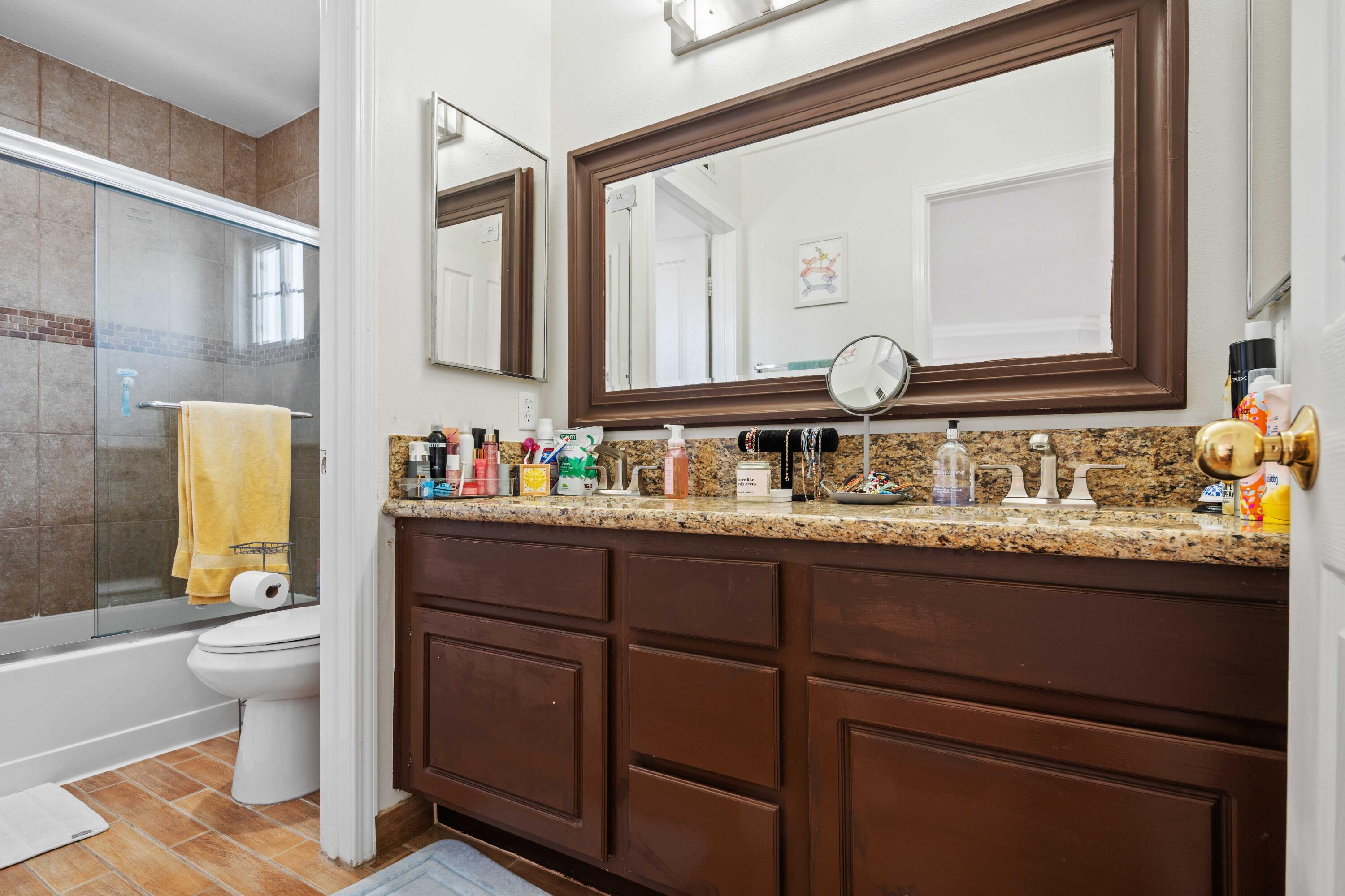 26089 Salinger Lane Stevenson Ranch, CA 91381 - Photo 30 of 47 a bathroom with a granite countertop sink and a mirror
