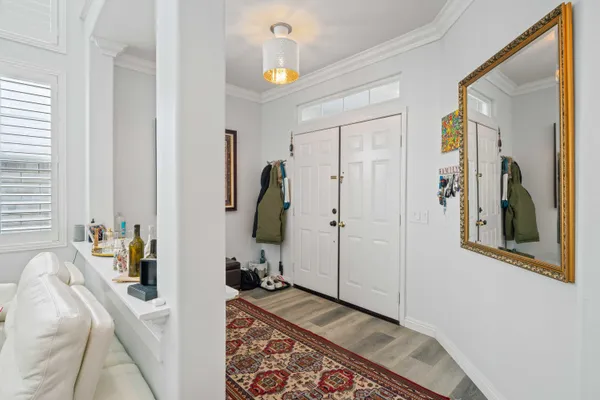 a living room with furniture a fireplace and large windows