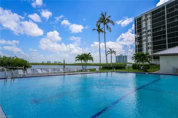 a view of swimming pool with outdoor seating and plants