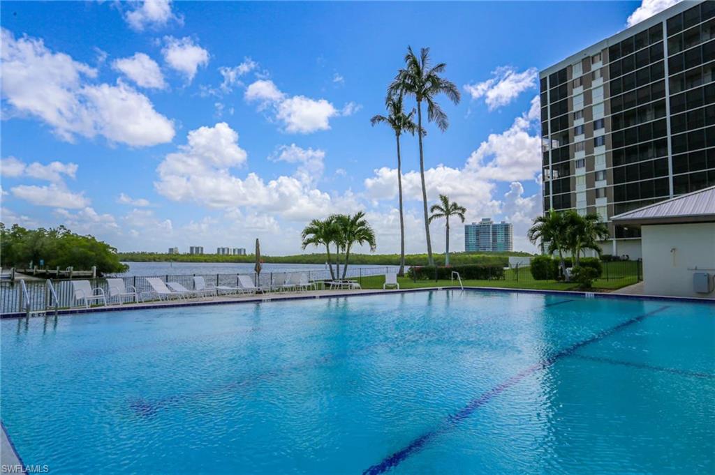 15 Bluebill Avenue, Unit 805 Naples, FL 34108 - Photo 15 of 29 a view of swimming pool with outdoor seating and plants