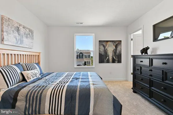 a bedroom with a bed and a television