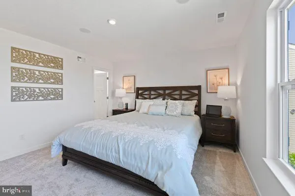 a bedroom with a bed and a lamp