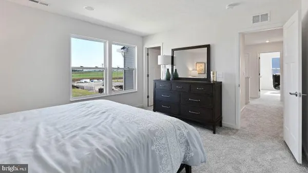 a bedroom with a bed and a dresser