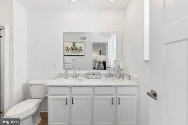 a bathroom with a sink toilet and mirror