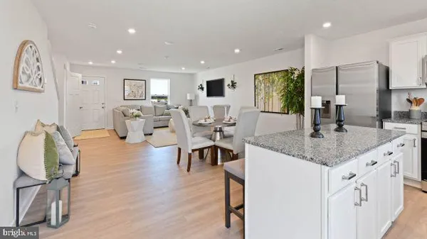 a kitchen with center island table and chairs