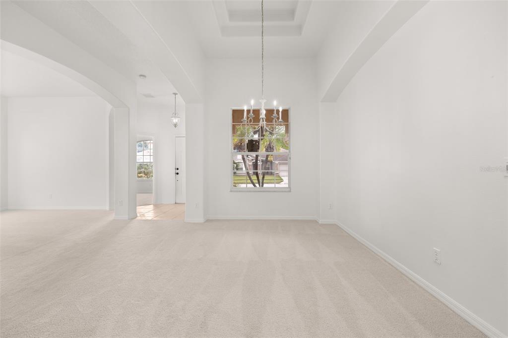2172 The Oaks Boulevard Kissimmee, FL 34746 - Photo 14 of 81 a view of an empty room with window and chandelier fan