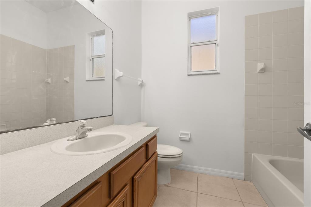 2172 The Oaks Boulevard Kissimmee, FL 34746 - Photo 28 of 81 a bathroom with a sink toilet and vanity