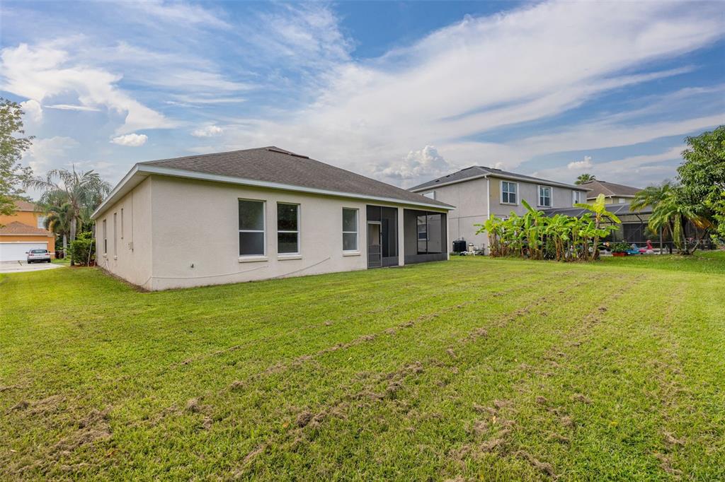 2172 The Oaks Boulevard Kissimmee, FL 34746 - Photo 43 of 81 a view of a house with backyard and garden