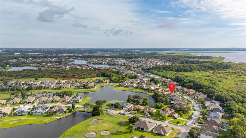 2172 The Oaks Boulevard Kissimmee, FL 34746 - Photo 59 of 81 an aerial view of a city with lots of residential buildings ocean and mountain view in back