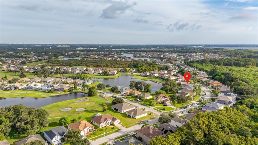 2172 The Oaks Boulevard Kissimmee, FL 34746 - Photo 61 of 81 an aerial view of a city with lots of residential buildings ocean and mountain view in back