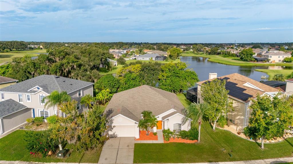 2172 The Oaks Boulevard Kissimmee, FL 34746 - Photo 7 of 81 an aerial view of a house with a garden and lake view