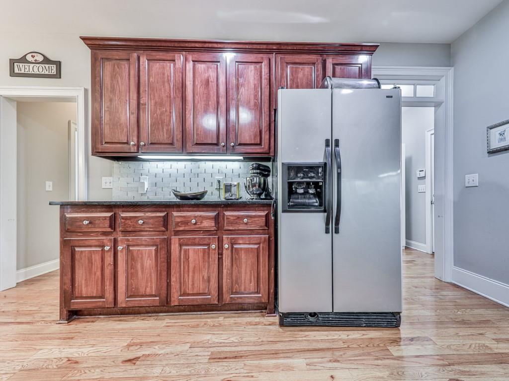 1076 Pinyan Lane Canton, GA 30115 - Photo 23 of 71 a kitchen with stainless steel appliances granite countertop a refrigerator and a sink