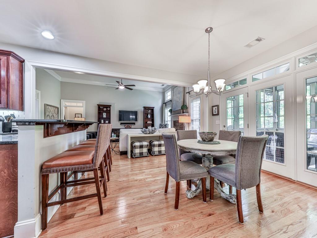 1076 Pinyan Lane Canton, GA 30115 - Photo 24 of 71 a view of a a dining room with furniture window and wooden floor