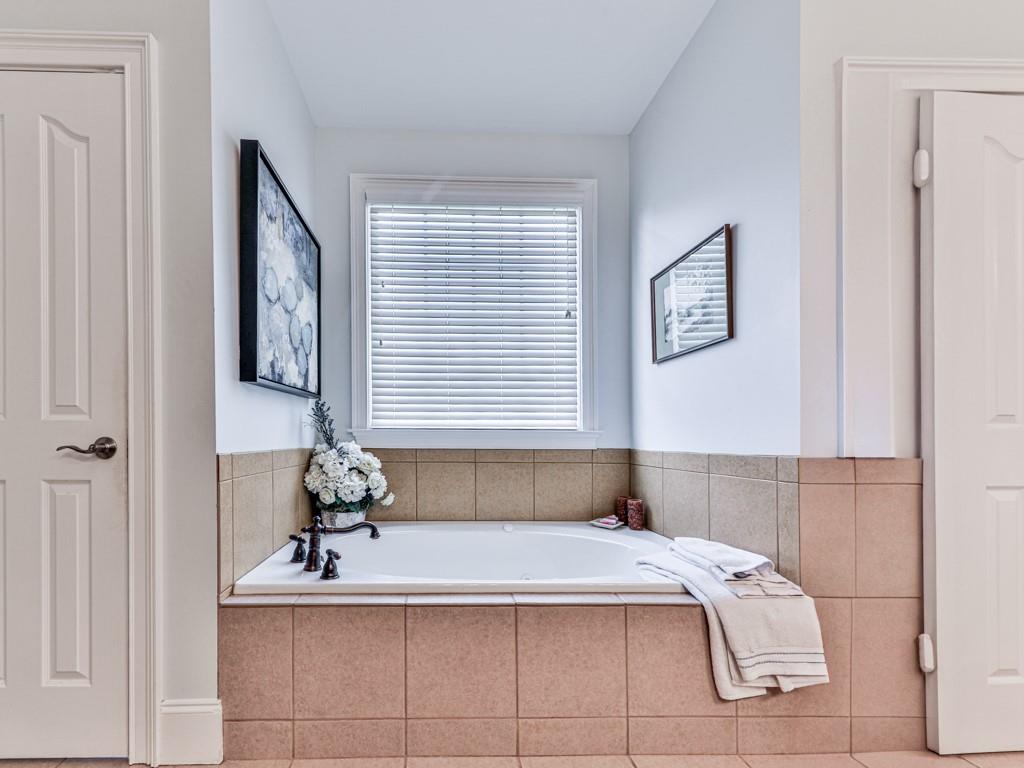 1076 Pinyan Lane Canton, GA 30115 - Photo 32 of 71 a bath tub sitting in a bathroom next to a window