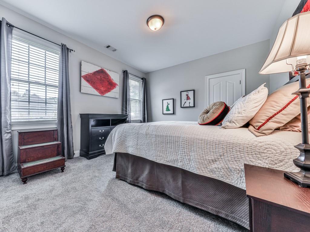 1076 Pinyan Lane Canton, GA 30115 - Photo 34 of 71 a bedroom with a bed and a painting on the wall