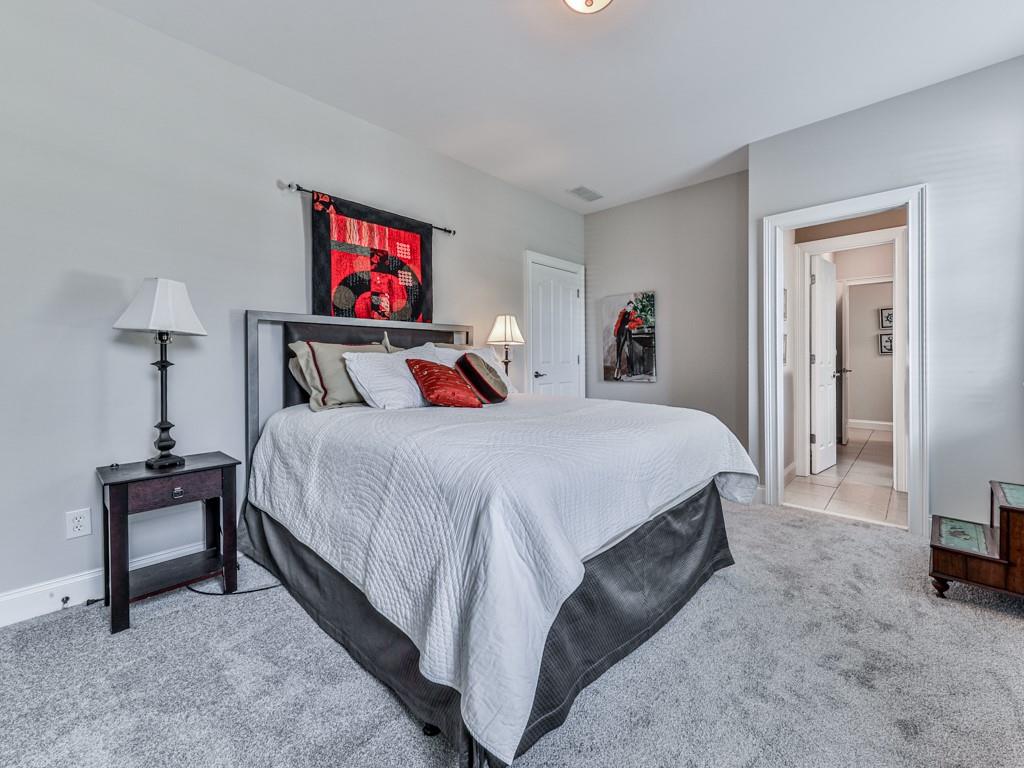 1076 Pinyan Lane Canton, GA 30115 - Photo 35 of 71 a bedroom with a bed and a flat screen tv