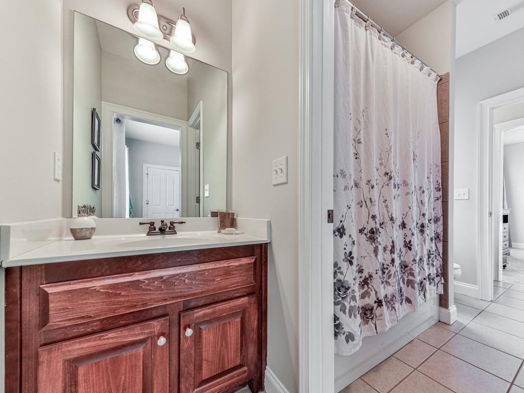 1076 Pinyan Lane Canton, GA 30115 - Photo 36 of 71 a bathroom with a sink vanity and a mirror