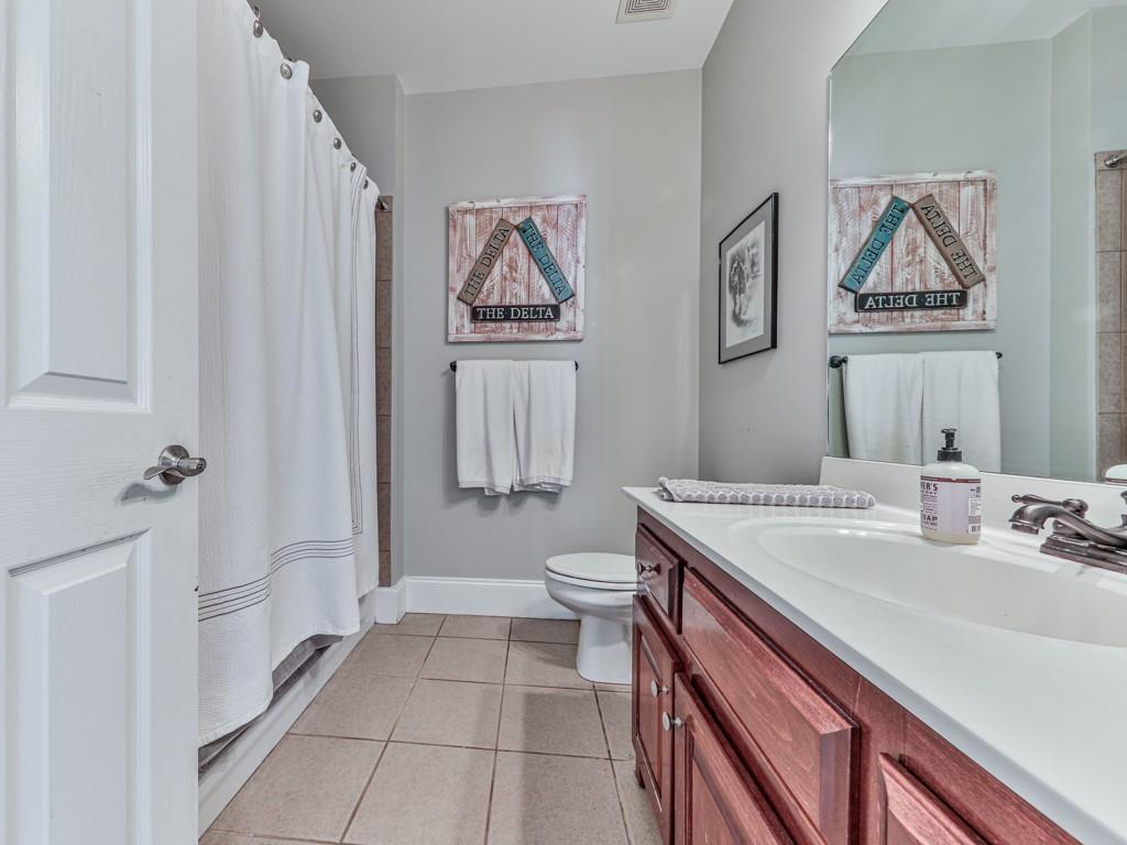 1076 Pinyan Lane Canton, GA 30115 - Photo 41 of 71 a bathroom with a sink a toilet and a mirror