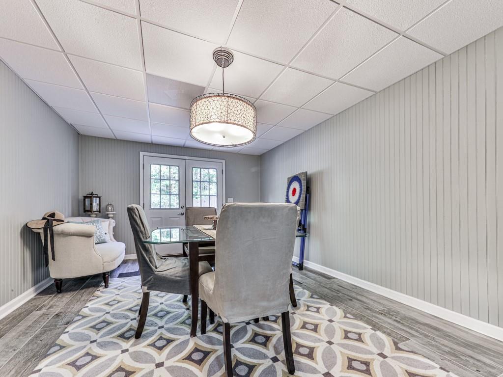 1076 Pinyan Lane Canton, GA 30115 - Photo 44 of 71 a view of a dining room with furniture window and wooden floor