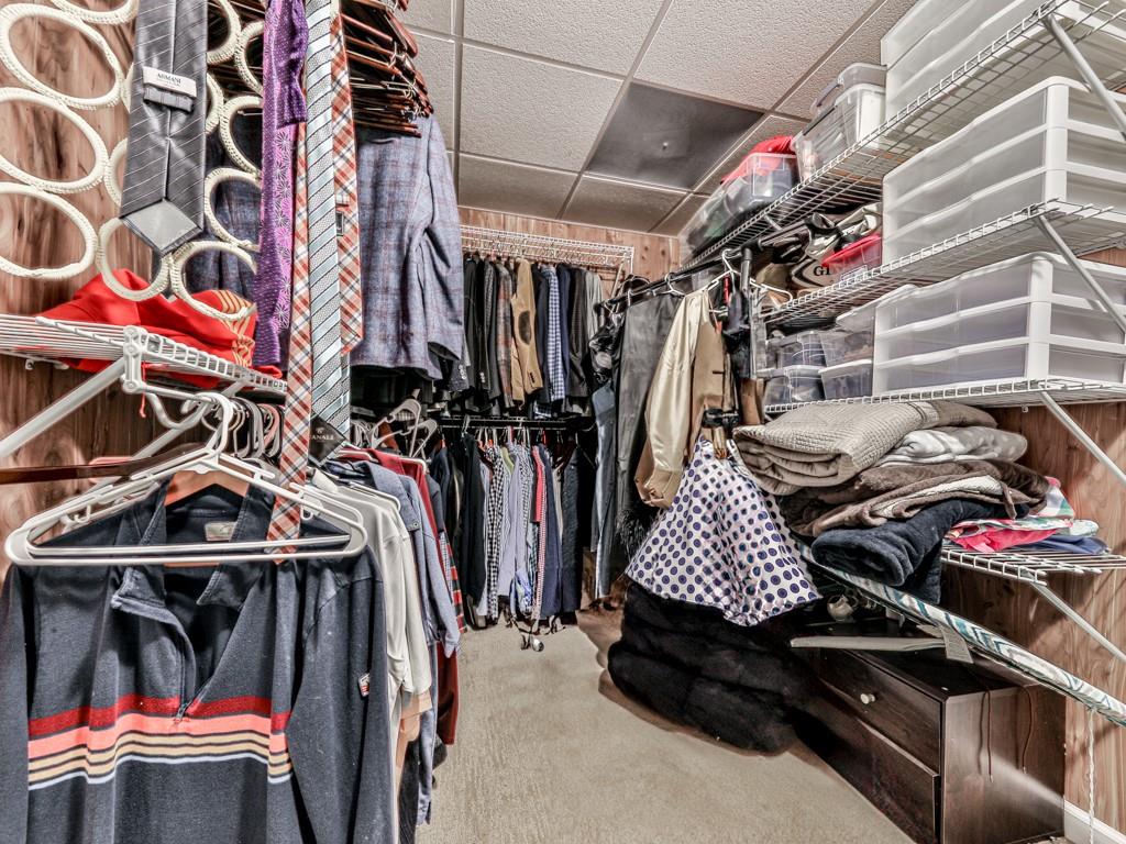 1076 Pinyan Lane Canton, GA 30115 - Photo 50 of 71 a view of walk in closet with clothes and shoes