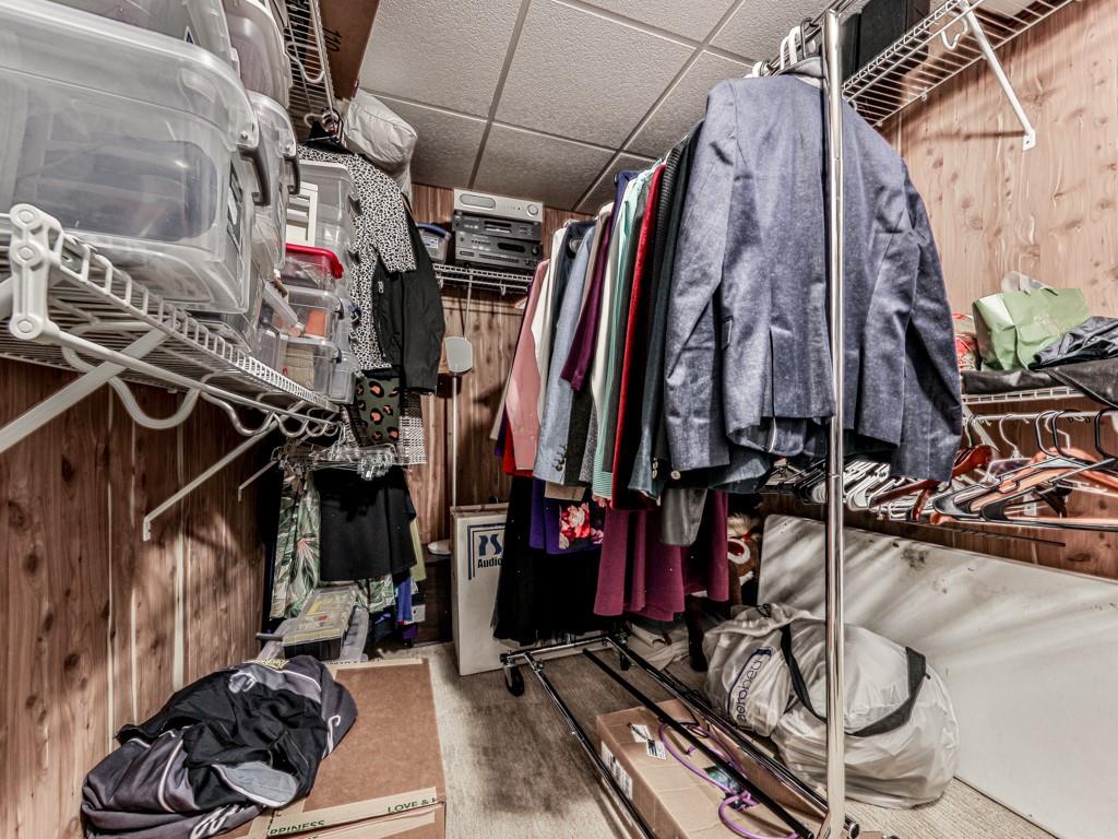 1076 Pinyan Lane Canton, GA 30115 - Photo 51 of 71 a view of walk in closet with clothes and shoes